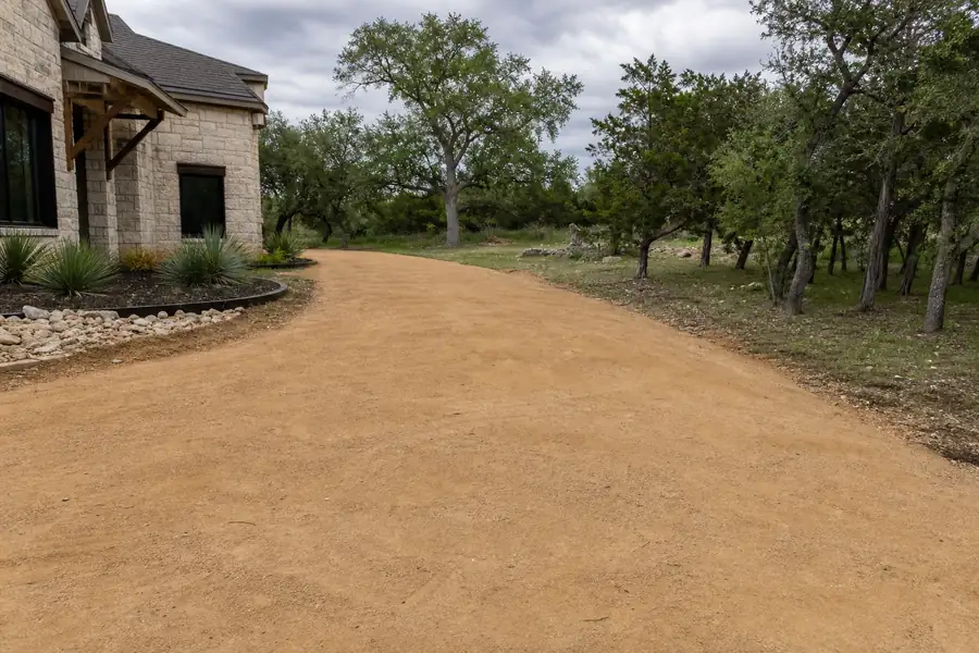 Compacted flex base driveway ready for gravel topping at a Texas home
