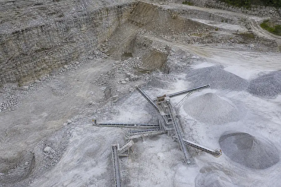 A limestone quarry with a crusher and stockpiles